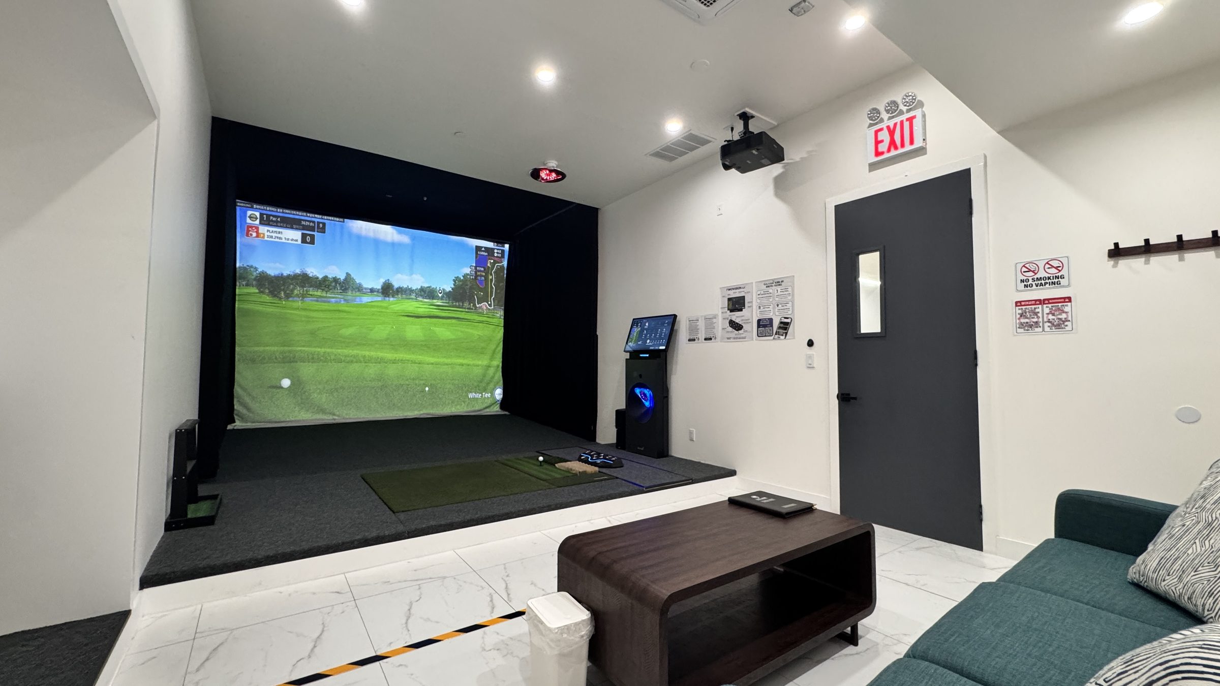 HOLE19 private room with a golf simulator and lounge seating